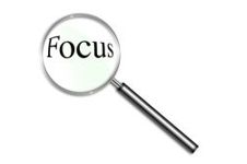 Magnifying glass focusing on word "focus"
