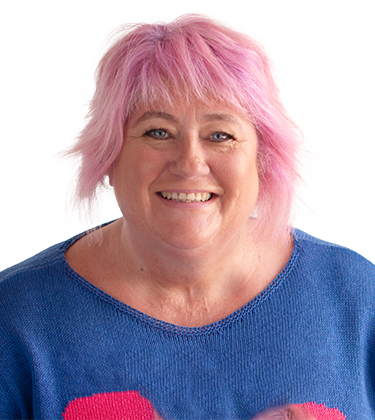 Sarah Harvey bio pic, smiling and pink haired